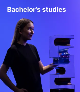 A KTU Faculty of Mechanical Engineering and Design student working with technological equipment against a blue decorative background. The faculty offers bachelor's studies. Choose KTU bachelor's studies.