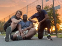 three international students on KTU campus basketball court in sunset